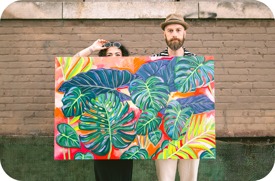 Reid and Claudia hold the tropical painting